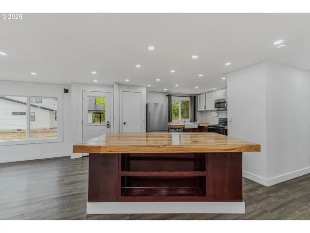 a view of kitchen with kitchen island a sink stainless steel appliances and couch