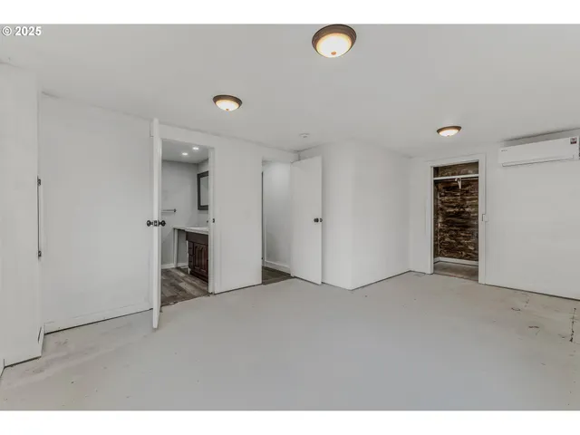 a view of an empty room with kitchen