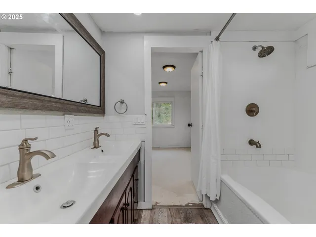 a bathroom with a sink a mirror and a shower