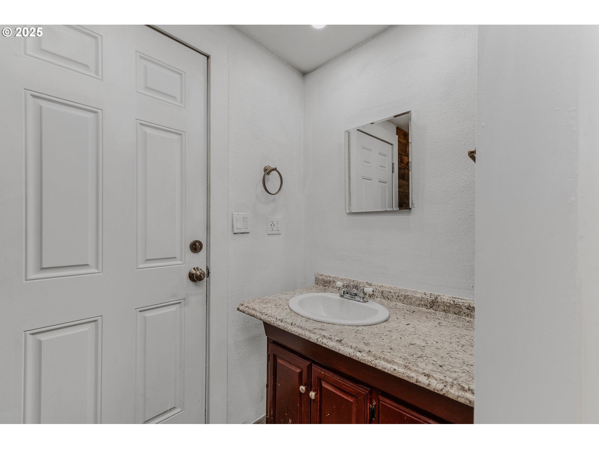 21617 Northeast 15th Avenue Ridgefield, WA 98642 - Photo 31 of 33 a bathroom with a granite countertop sink a mirror and a