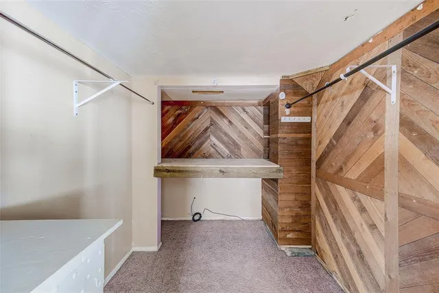 a view of a storage & utility room with a refrigerator
