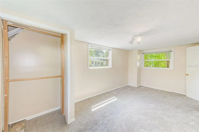 a view of a hallway with bathroom and a bathroom