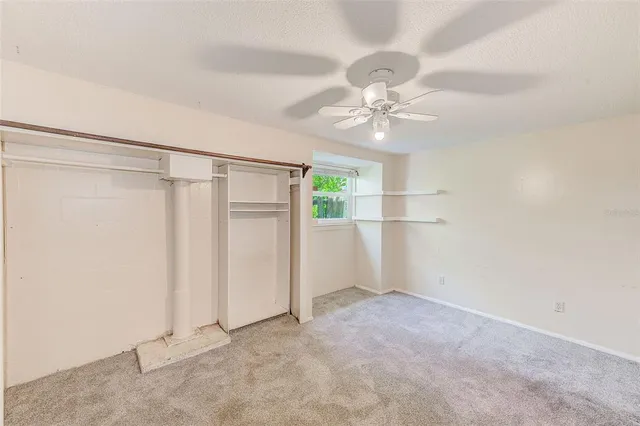 a view of house with backyard and glass windows