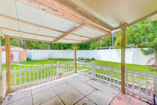 a aerial view of a house with swimming pool next to a big yard