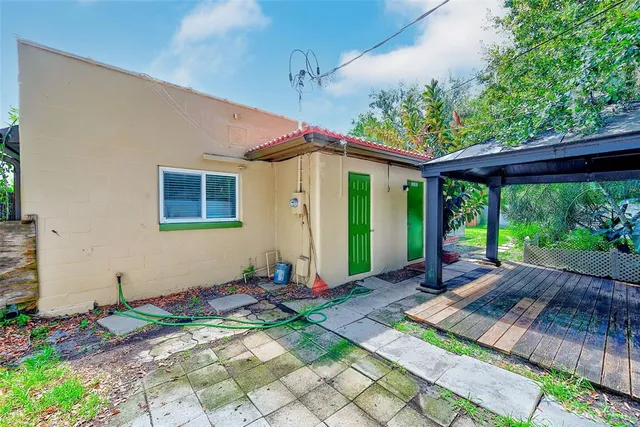 a view of a backyard with wooden floor and wooden fence