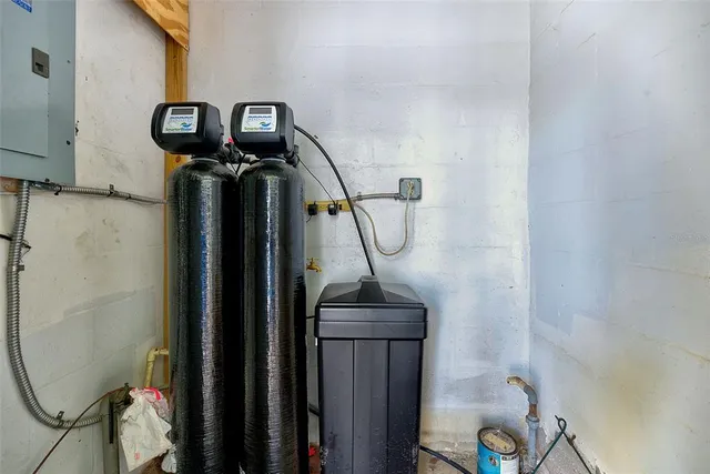 a view of a backyard with potted plants and wooden fence