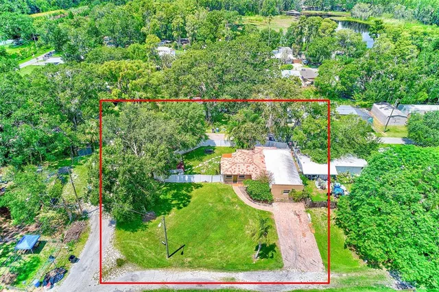 a view of a house with a backyard