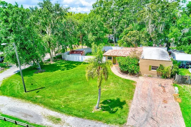 an aerial view of a house with a yard and lake view