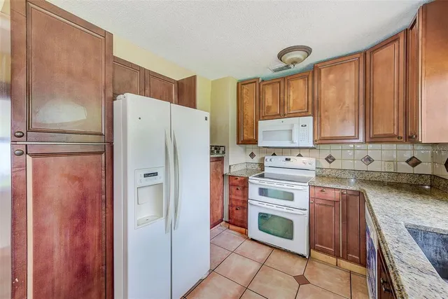 a kitchen with a refrigerator stove and cabinets