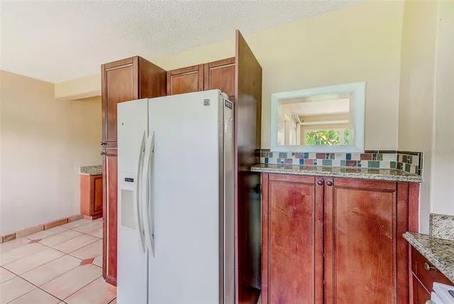 a white refrigerator freezer sitting in a kitchen