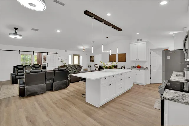 a living room with furniture a ceiling fan and a rug