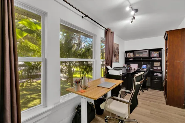 a bathroom with a granite countertop sink a mirror and shower