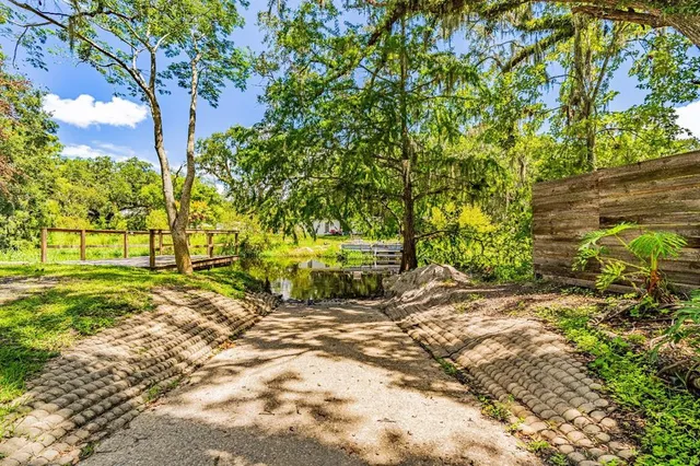 a view of a balcony with wooden floor and fence