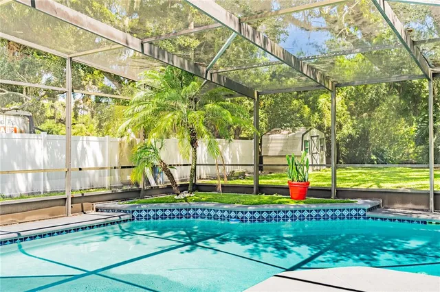 a view of a swimming pool with a yard