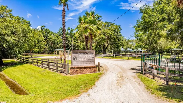 a view of a house with backyard and a garden