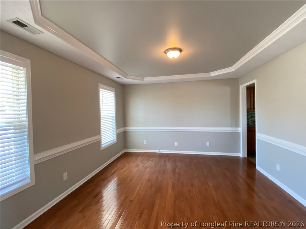 58 Polk Street Spring Lake, NC 28390 - Photo 4 of 26 an empty room with wooden floor and windows