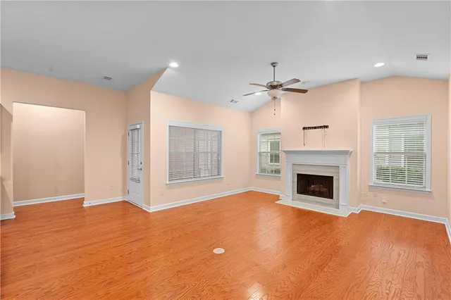 a view of an empty room with a fireplace and a window