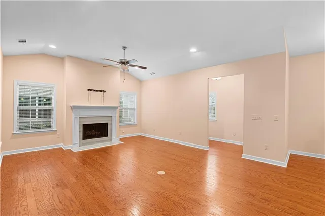 a large kitchen with stainless steel appliances granite countertop a large stove a sink dishwasher and a refrigerator with wooden floor