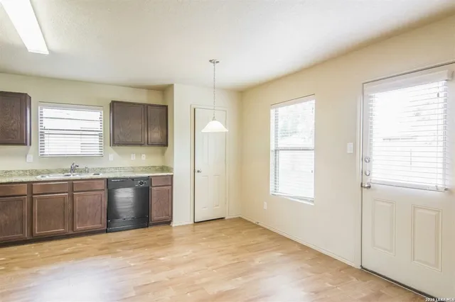 a view of a kitchen with granite countertop cabinets and refrigerator