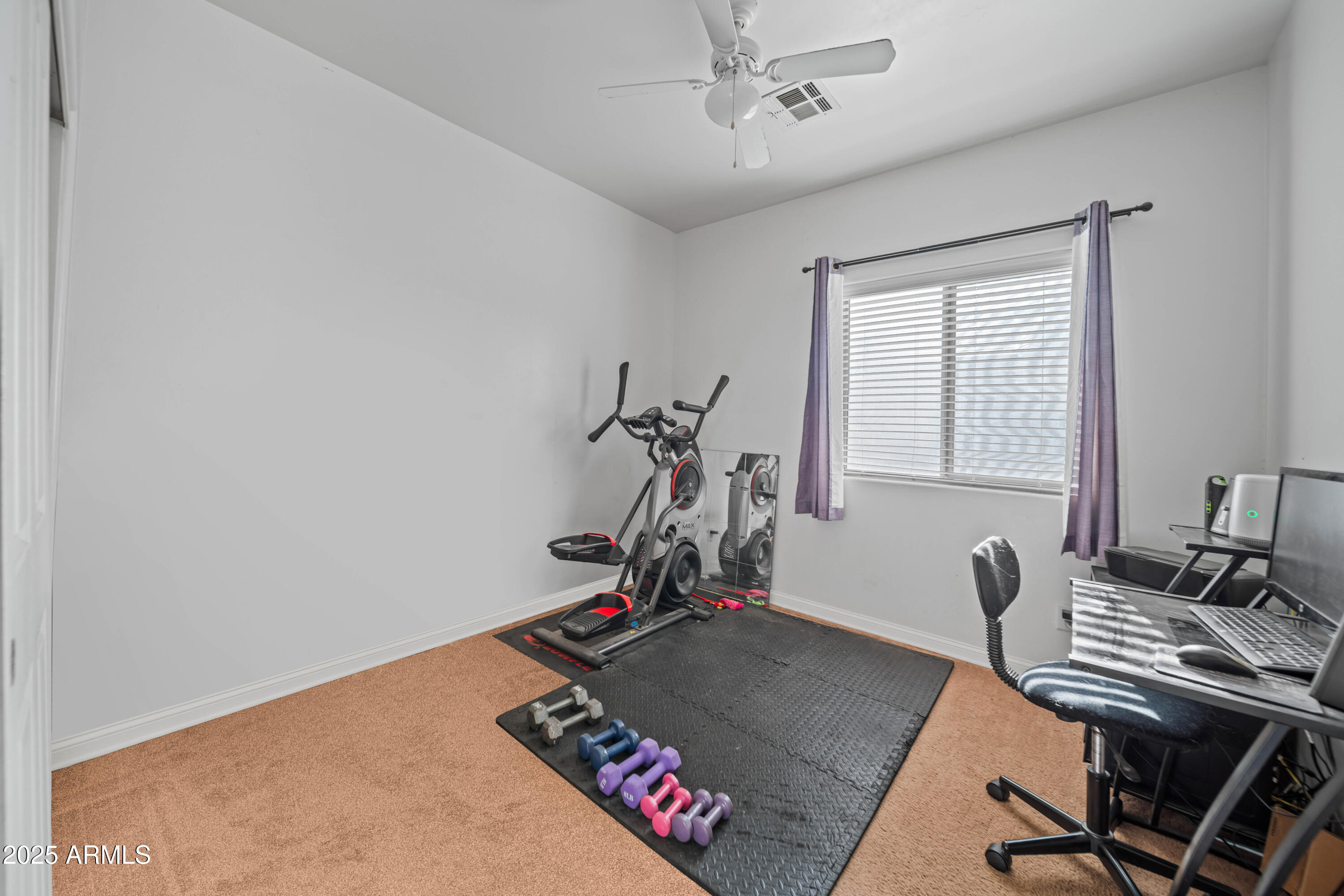 456 Guskin Road Morristown, AZ 85342 - Photo 7 of 17 a room with gym equipment and a window