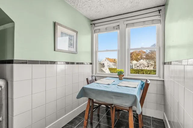 a view of a dining room with furniture and window