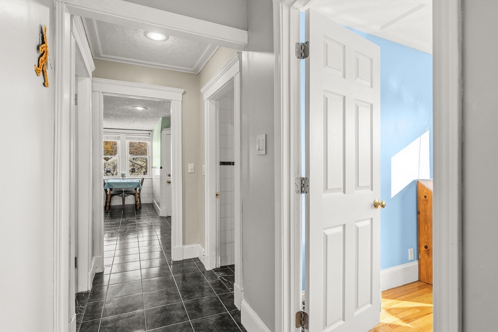 4 Elm Street, Unit 3 Peabody, MA 01960 - Photo 15 of 24 a view of a hallway with wooden floor and living room