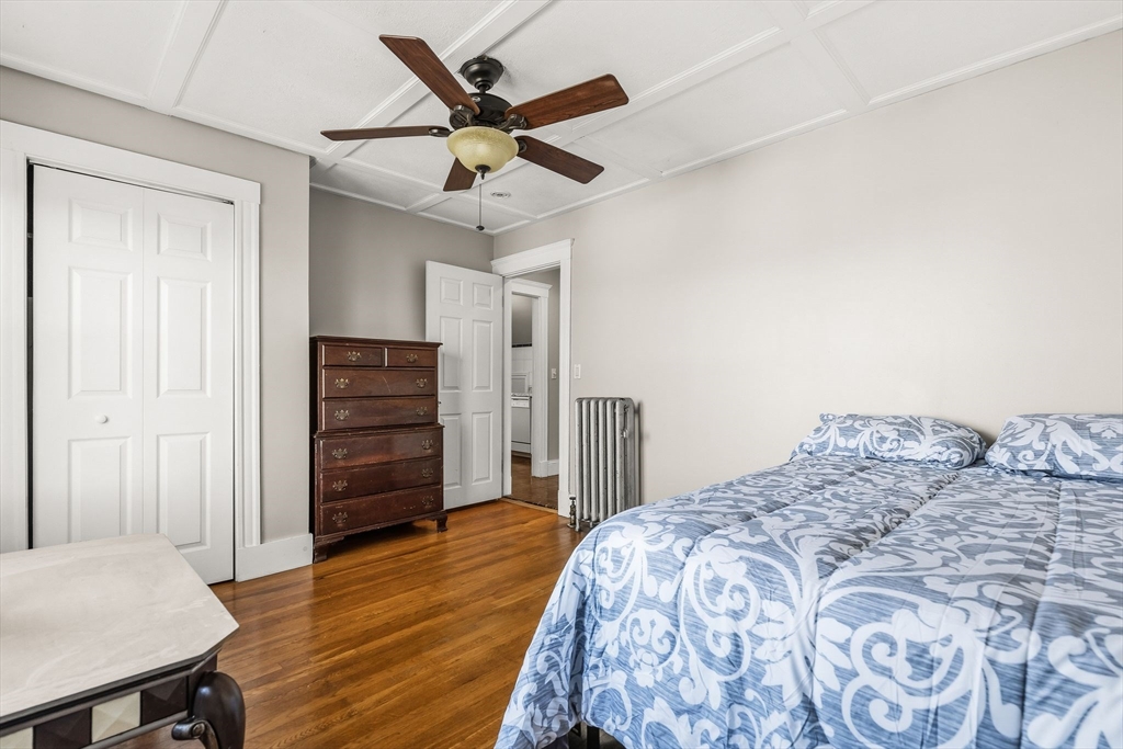 4 Elm Street, Unit 3 Peabody, MA 01960 - Photo 17 of 24 a bedroom with a bed and a chandelier