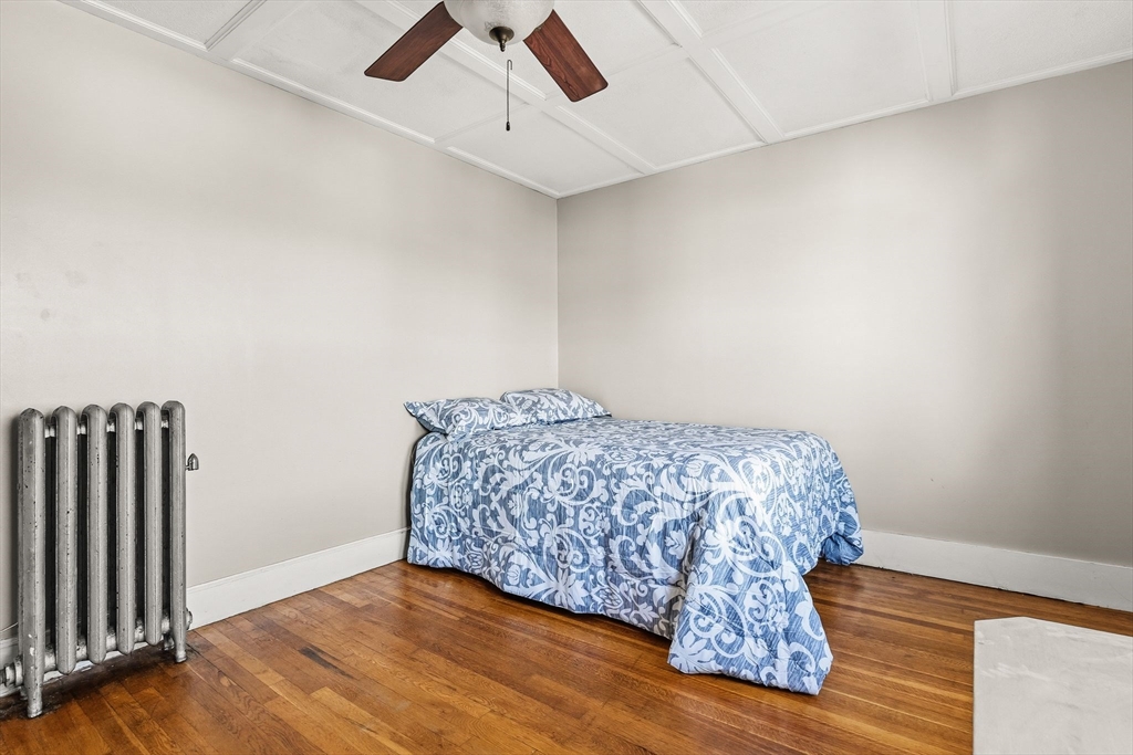 4 Elm Street, Unit 3 Peabody, MA 01960 - Photo 18 of 24 a bedroom with a bed and wooden floor