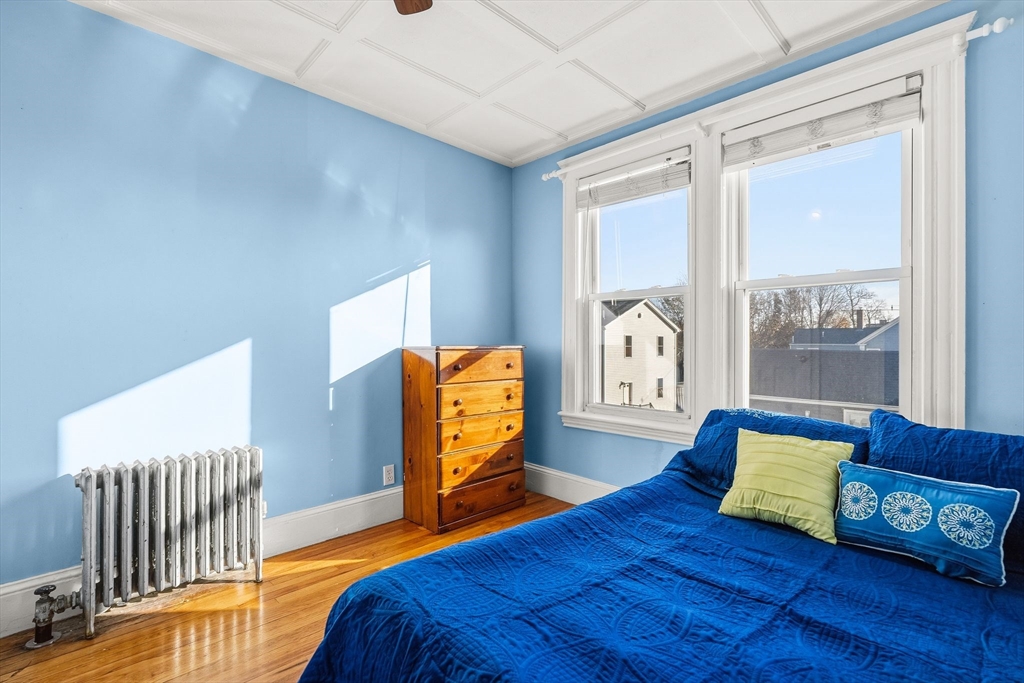 4 Elm Street, Unit 3 Peabody, MA 01960 - Photo 20 of 24 a bedroom with a bed and wooden floor