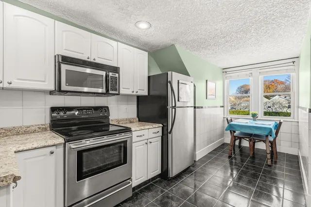 a kitchen with a refrigerator stove and microwave