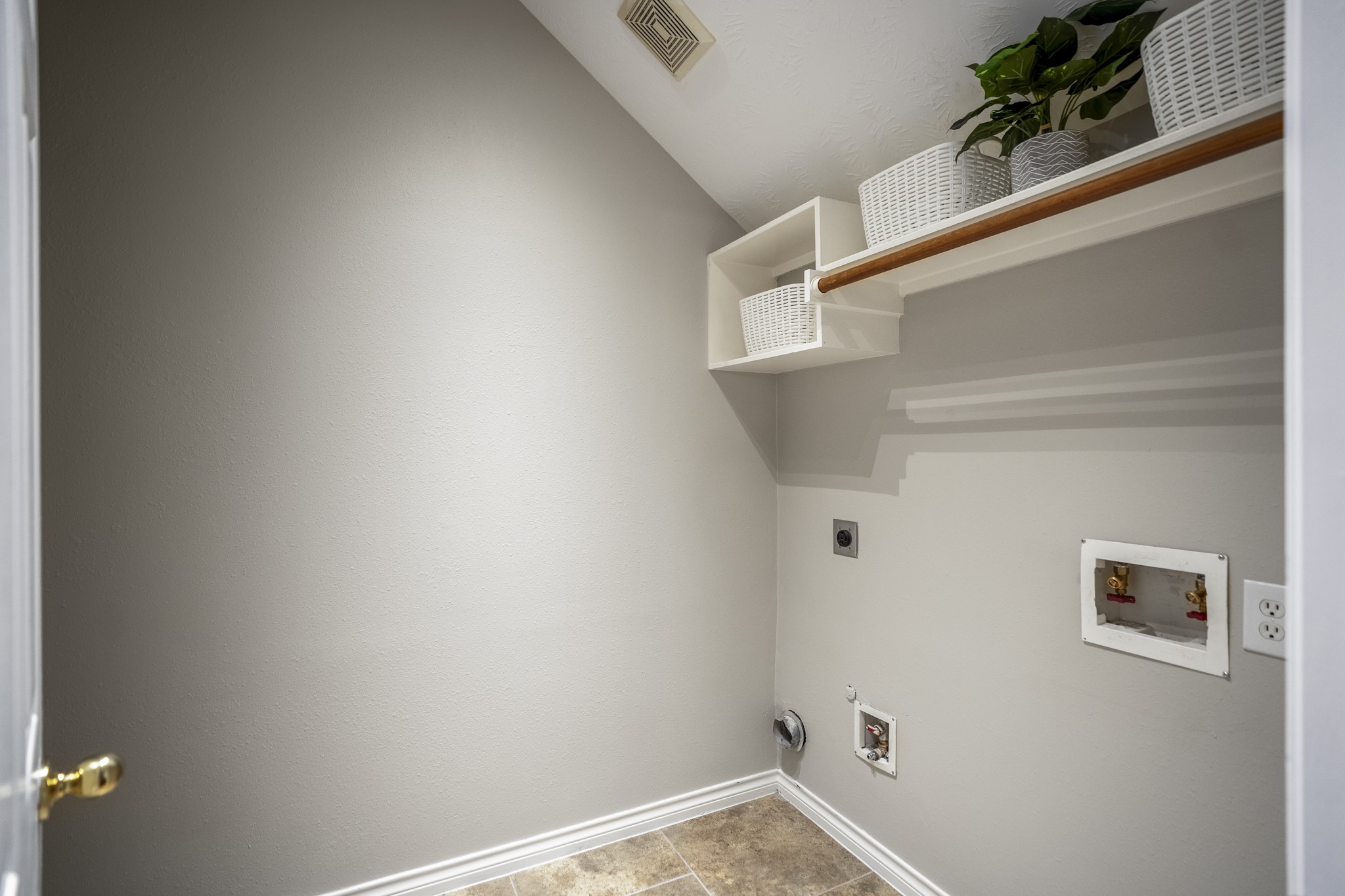 6311 Sparrows Glen Lane Spring, TX 77379 - Photo 30 of 50 Tucked off the main hallway downstairs, the laundry room keeps daily routines neatly contained, with tile flooring, overhead shelving, and room to customize storage around the washer/dryer connections.