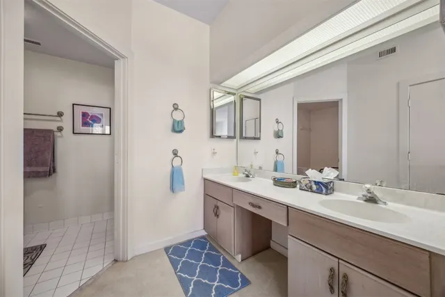 a view of a patio with table and chairs next to a yard with a large tree