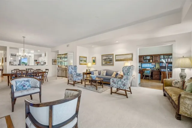 a living room with furniture and large windows