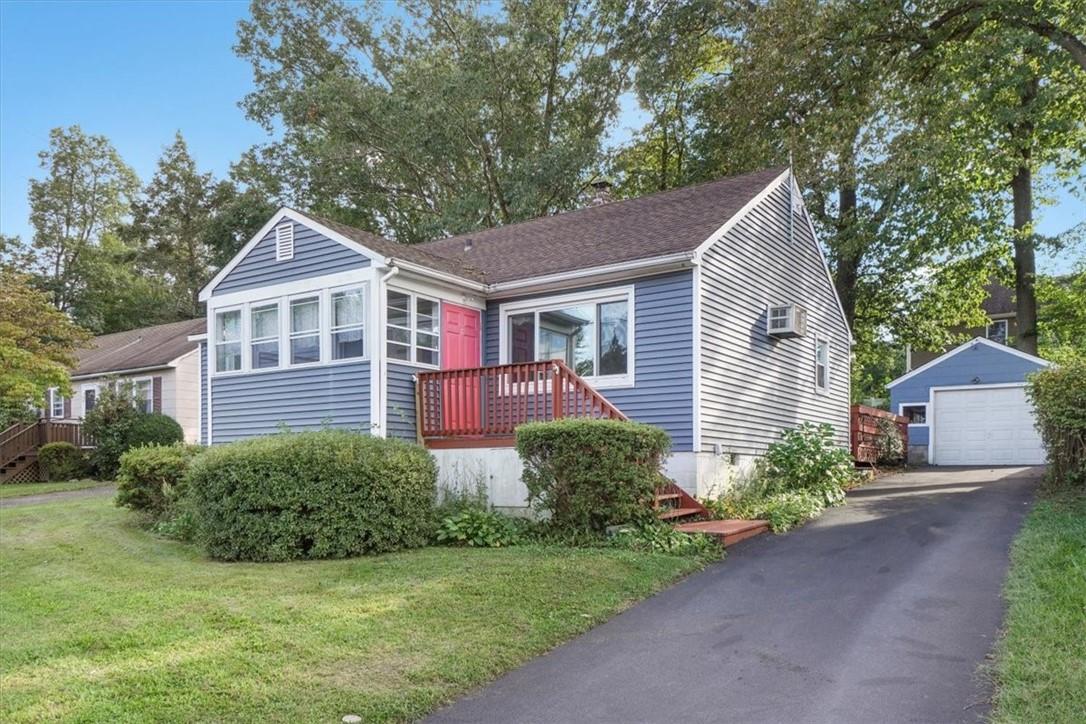 a front view of a house with a garden and plants