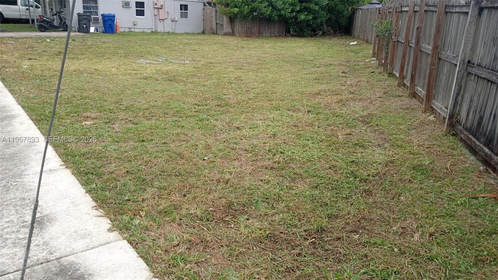 5825 Fillmore Street Hollywood, FL 33021 - Photo 5 of 6 a view of a yard with wooden fence