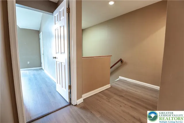a view of a hallway with wooden floor