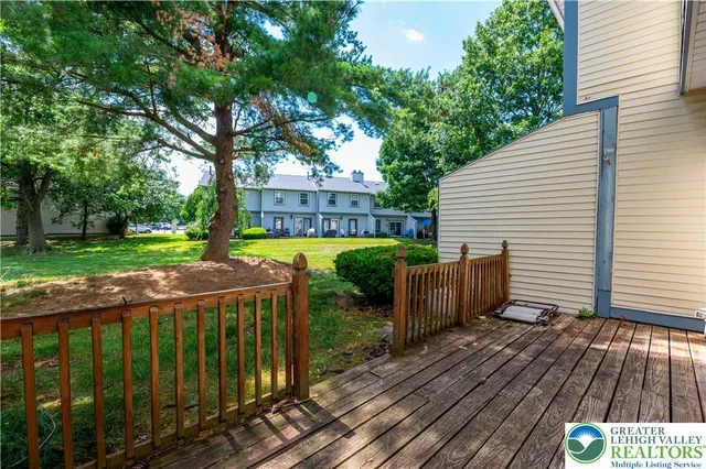 a view of a wooden deck with a yard