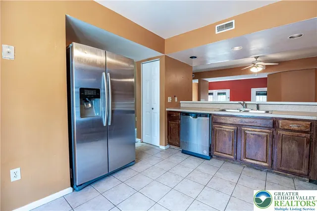 a kitchen with stainless steel appliances granite countertop a sink counter space and cabinets