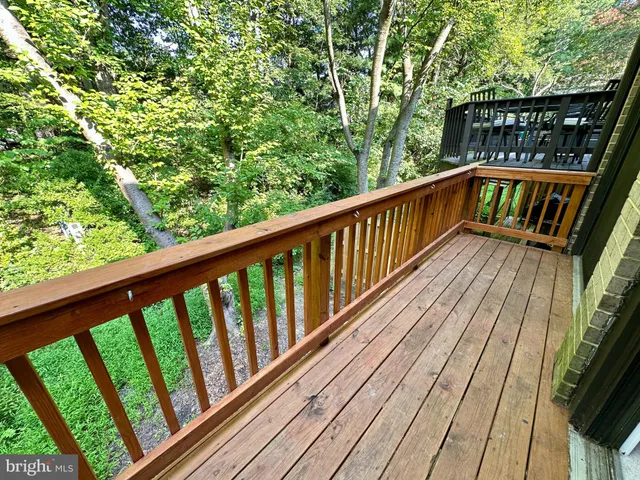 a view of balcony with wooden floor and fence