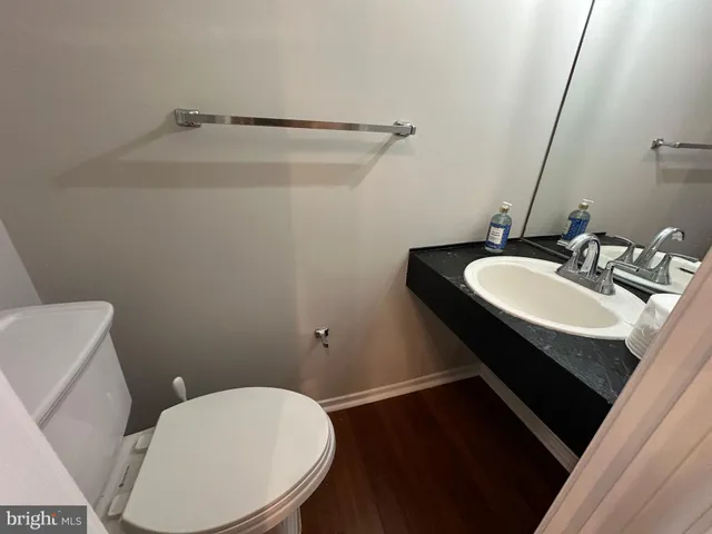 a bathroom with a sink toilet and a mirror