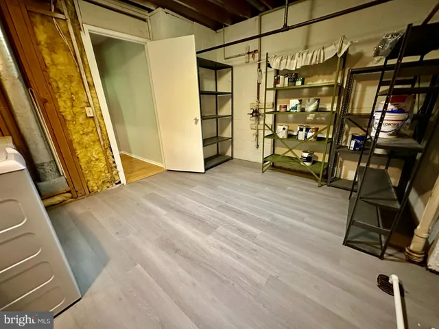 a view of a backyard with wooden fence and large trees