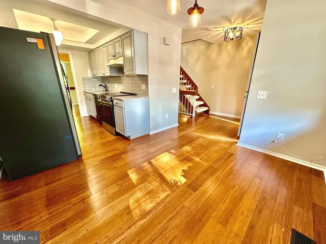 a view of a kitchen from a hallway