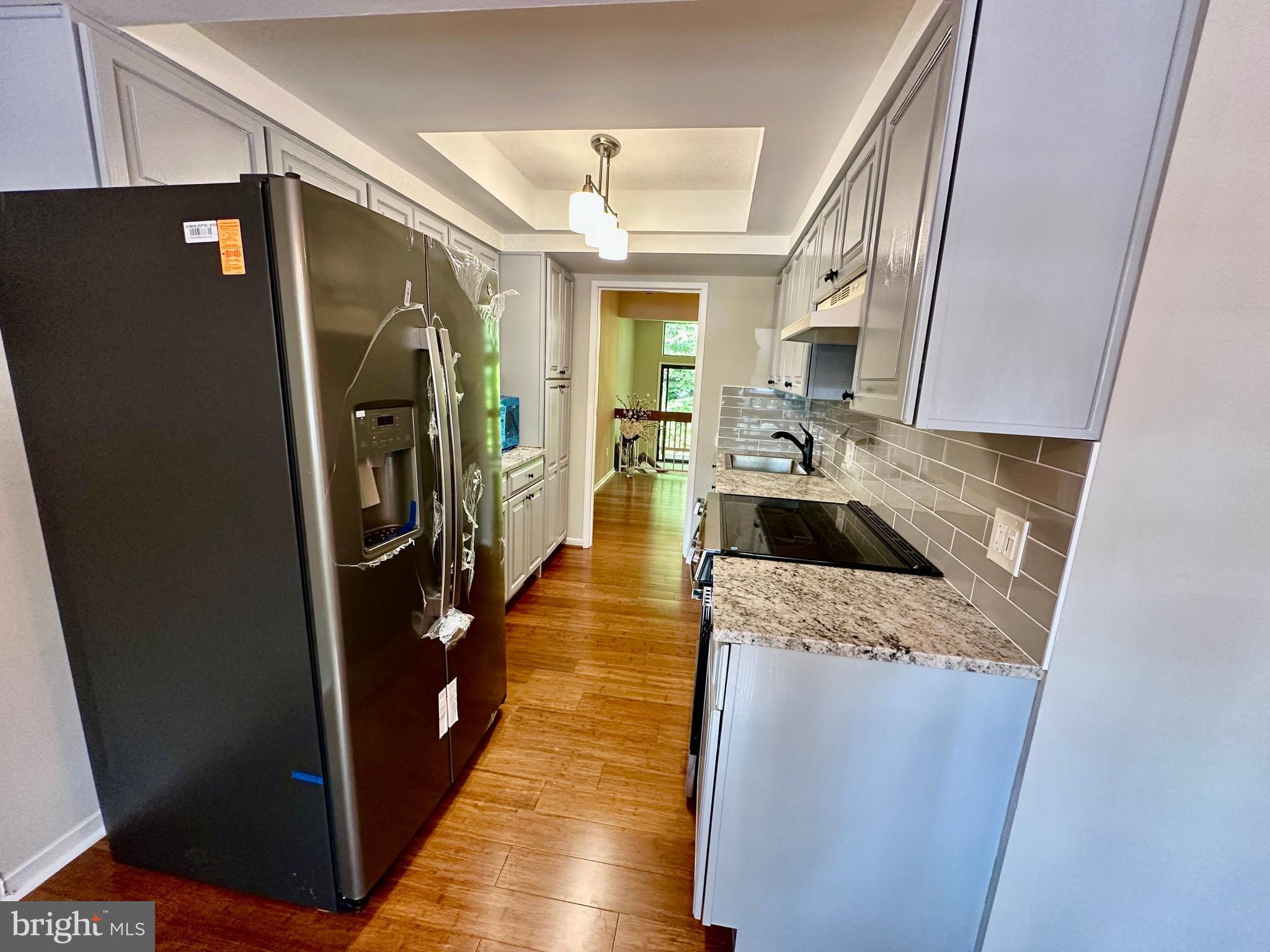 1526 Scandia Circle Reston, VA 20190 - Photo 6 of 29 a kitchen with a sink a refrigerator and washer