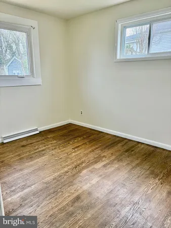 a view of a room with wooden floor and window