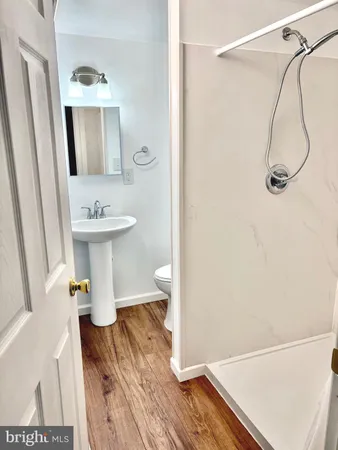 a bathroom with a sink a toilet and a mirror