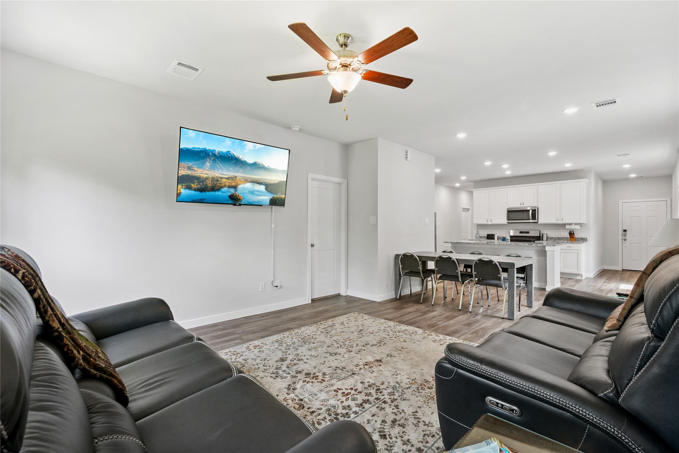 16934 Needlepoint Drive Conroe, TX 77302 - Photo 11 of 24 a living room with furniture and kitchen view