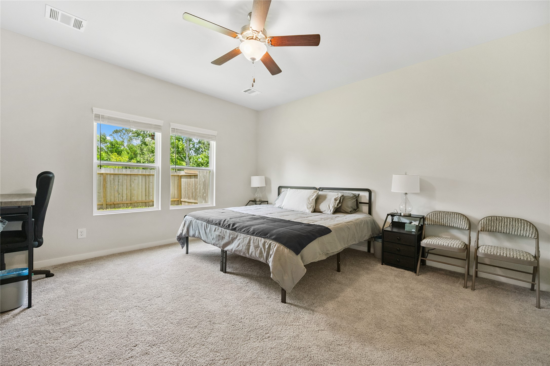 16934 Needlepoint Drive Conroe, TX 77302 - Photo 12 of 24 a spacious bedroom with a bed a desk and chair
