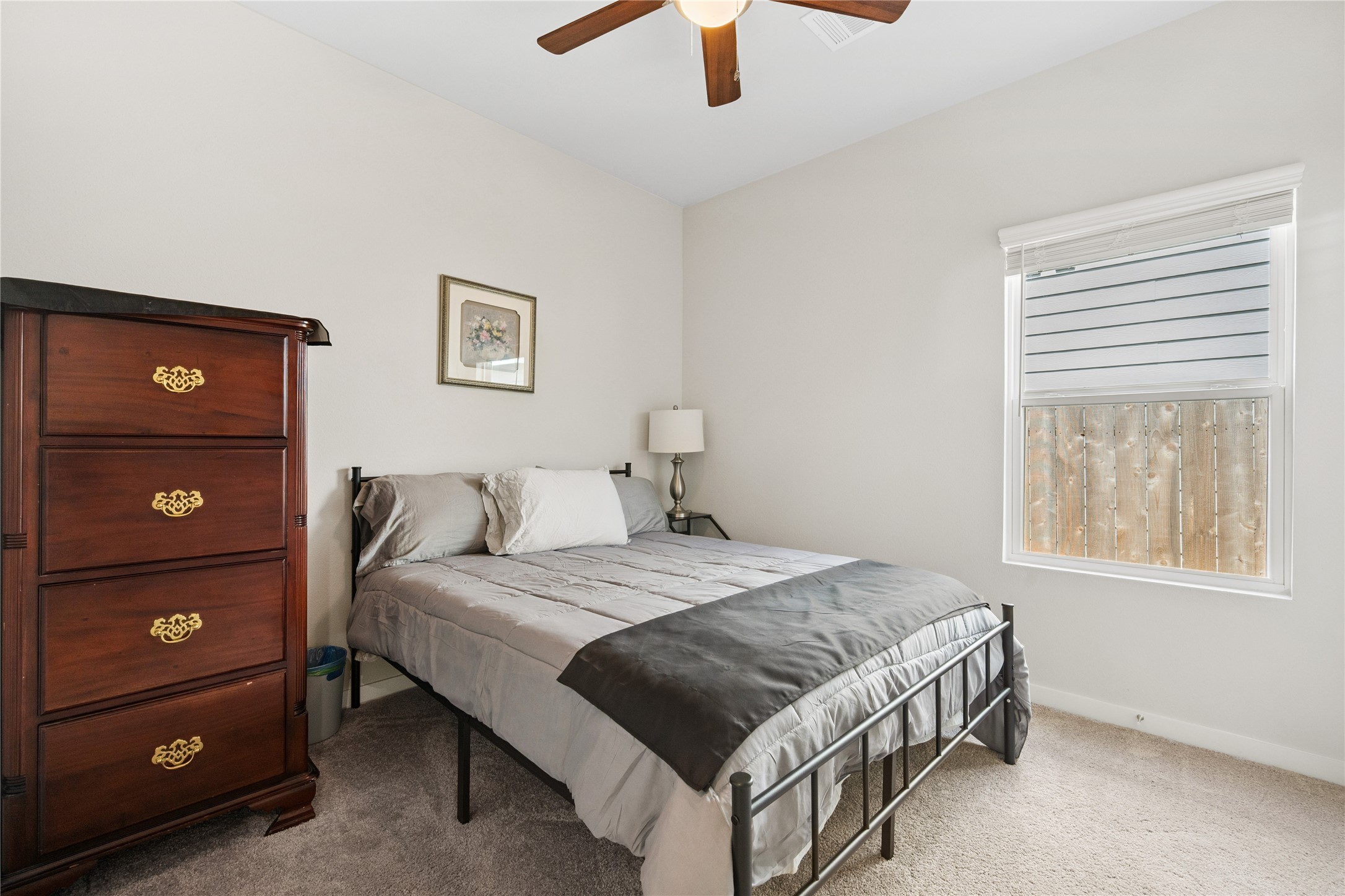 16934 Needlepoint Drive Conroe, TX 77302 - Photo 18 of 24 a bedroom with a bed and a lamp on dresser