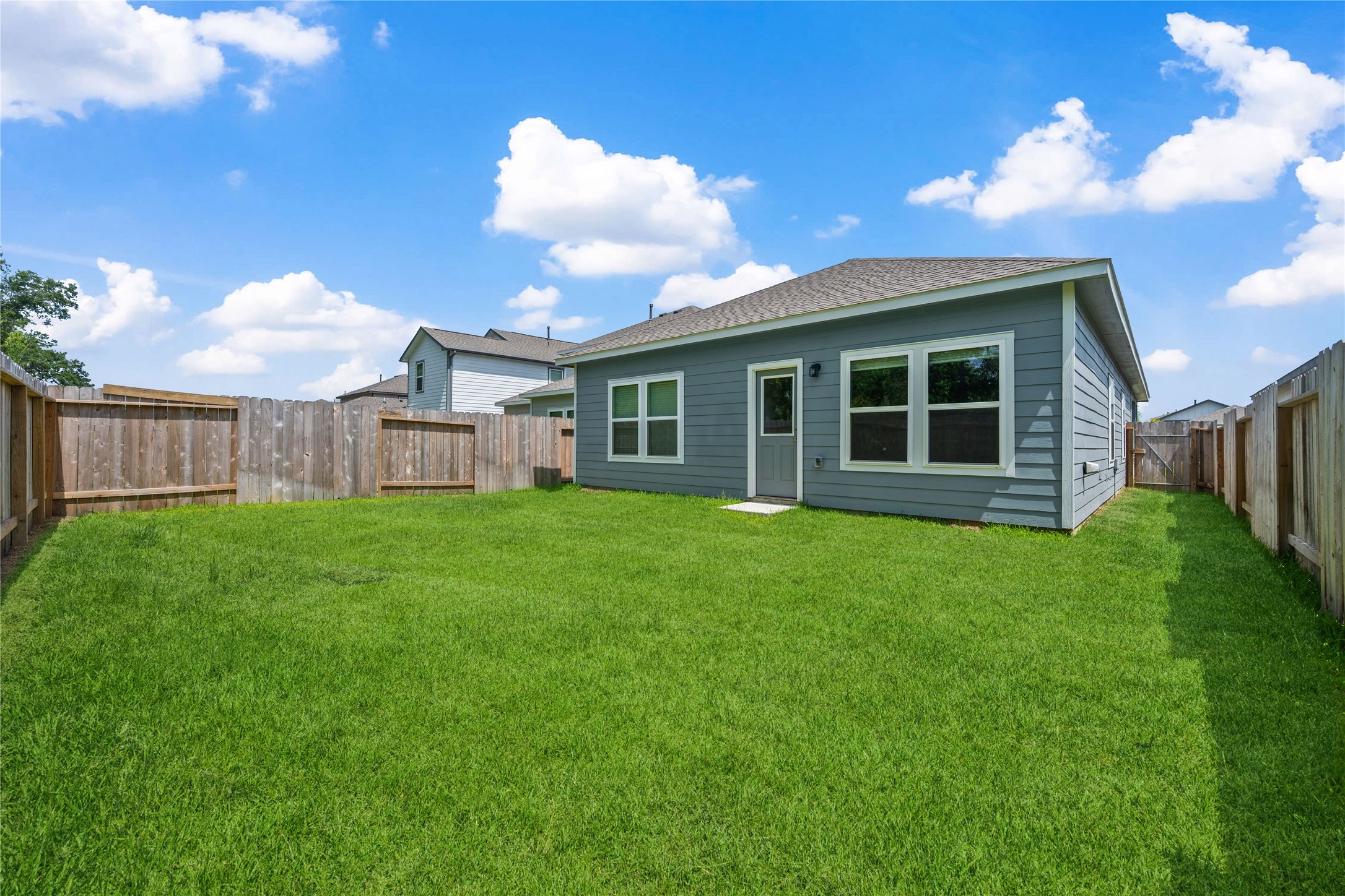 16934 Needlepoint Drive Conroe, TX 77302 - Photo 23 of 24 a view of a house with backyard and garden