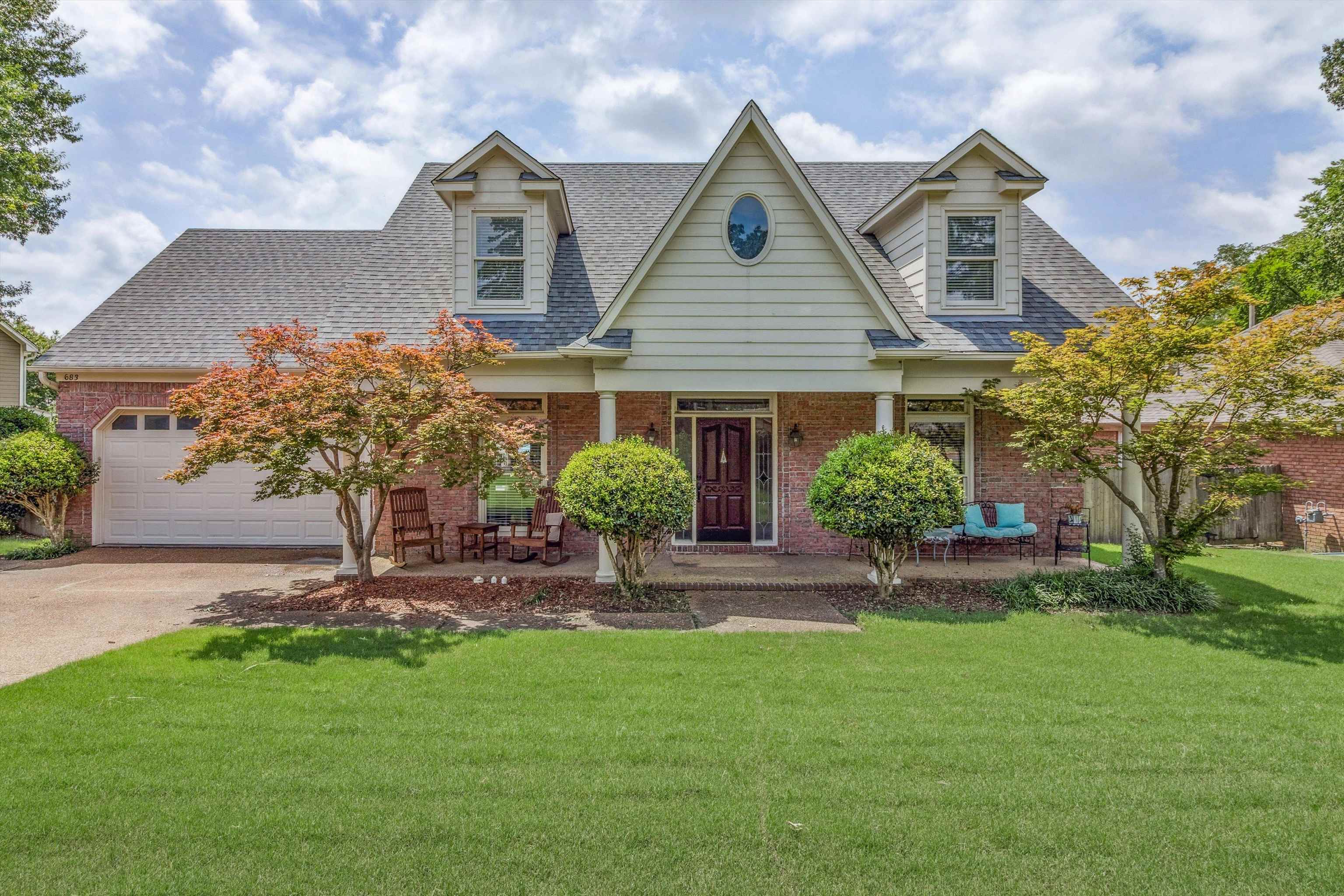 a front view of house with a garden
